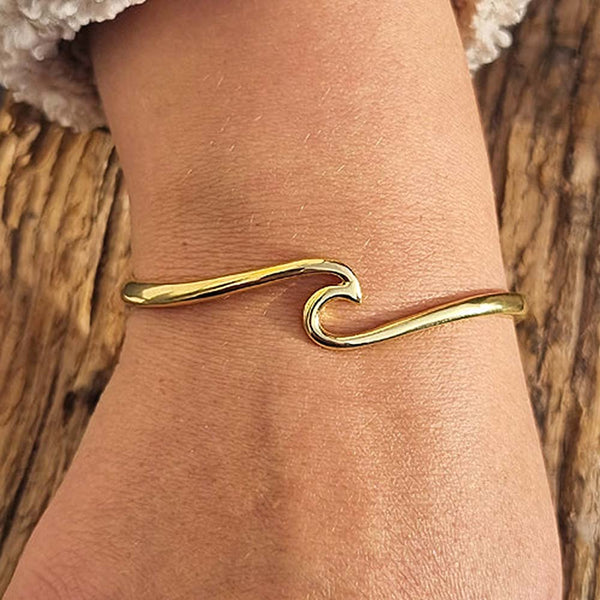 Gold Ocean Wave Bracelet on woman's wrist