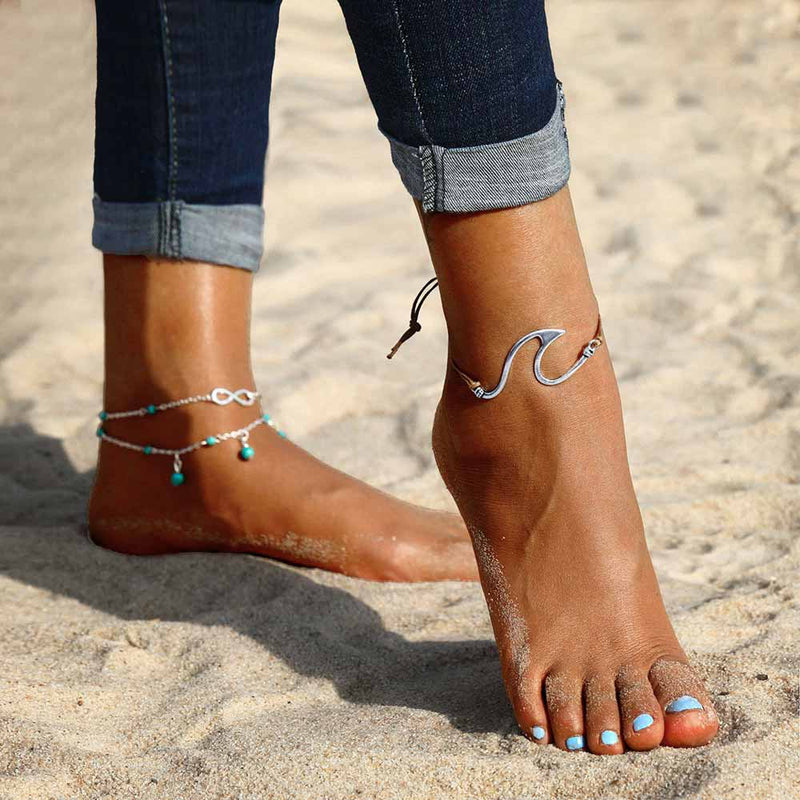 Woman on the beach wearing Wave Anklets 