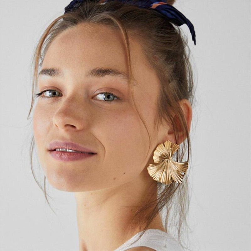 Women wearing a gold Elkhorn Coral Earrings