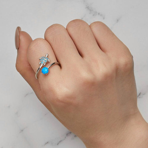 Opal Turtle Ring on women's index finger