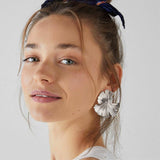 Woman wearing a silver Coral Drop Earring