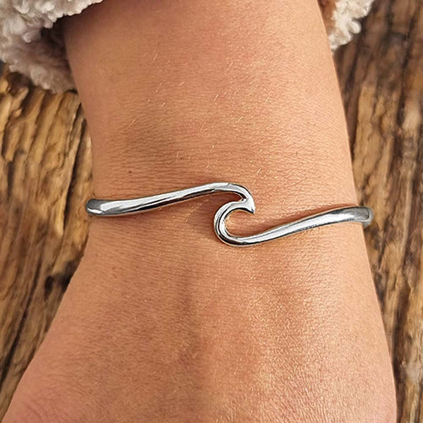 Woman's wrist wearing a silver Wave Cuff Bracelet