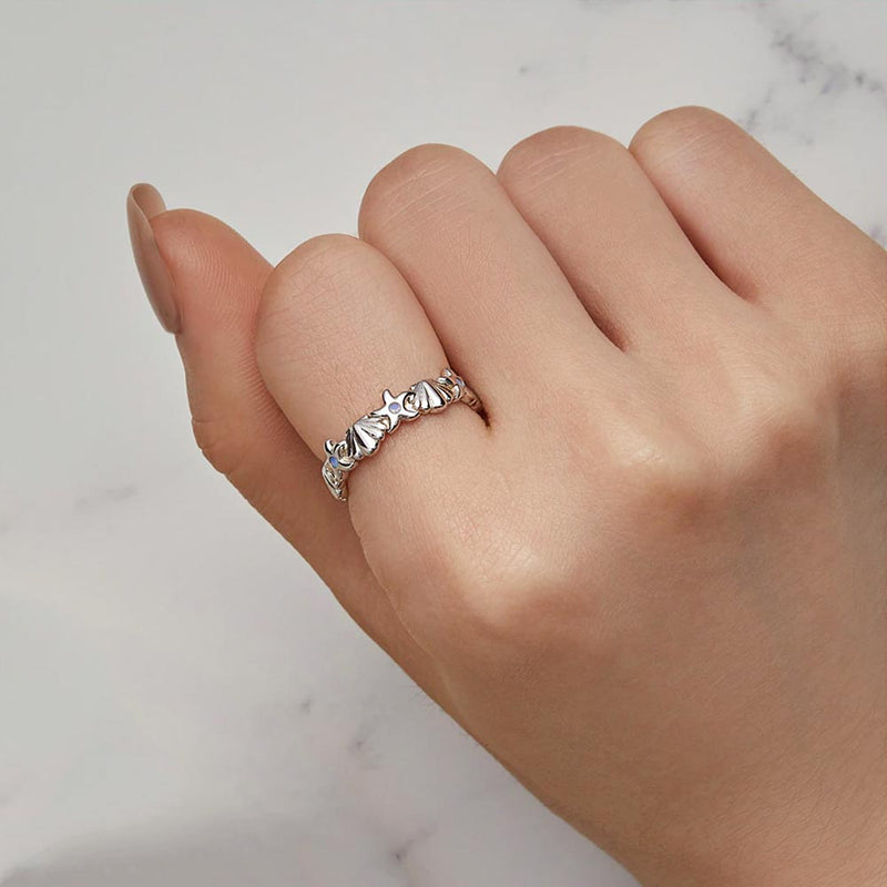 Woman wearing a silver Starfish and Seashell Ring