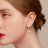 Women wearing a conch hoop earring