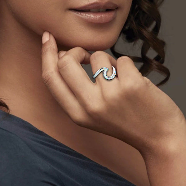 Women wearing a white opal wave ring 