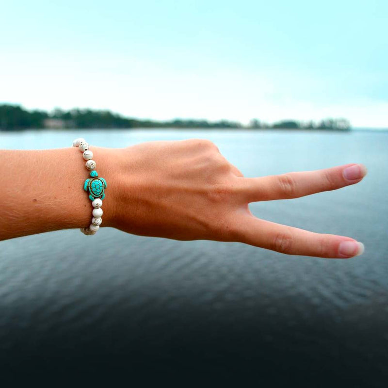 White Turtle Bead Bracelet on women's wrist