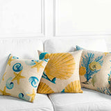 Three coral reef throw pillows on white sofa