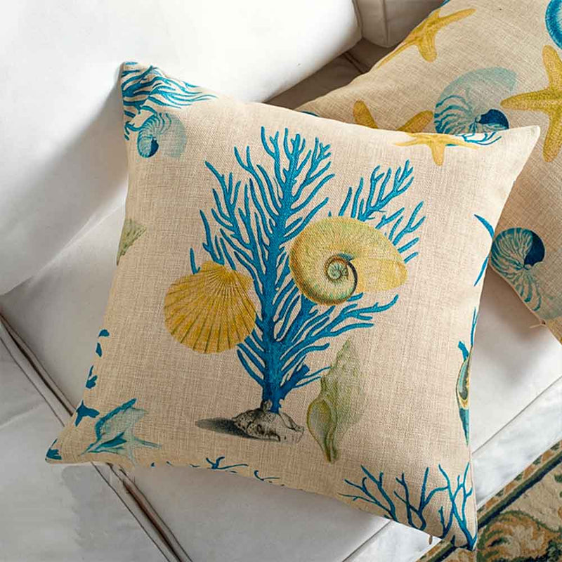 A pair of cushions with a coral reef design print
