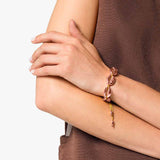 Rose Cowrie Bracelet on woman’s wrist 
