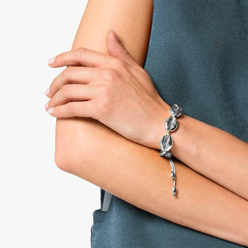 Woman wearing Silver Cowrie Bracelet with wax cord 