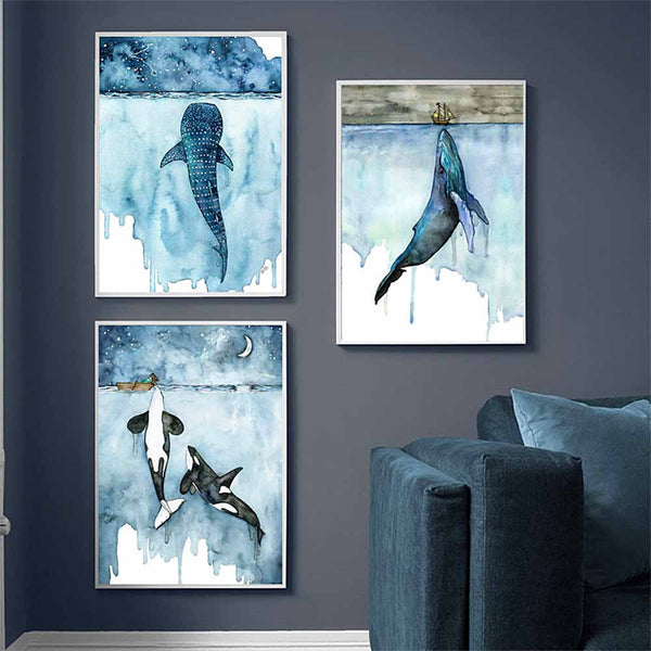 Trio of whale canvas prints on blue wall