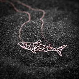 Rose Gold Shark Pendant on Black Sand 