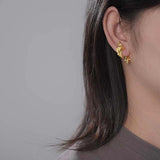 Woman wearing a double-sided fish earring