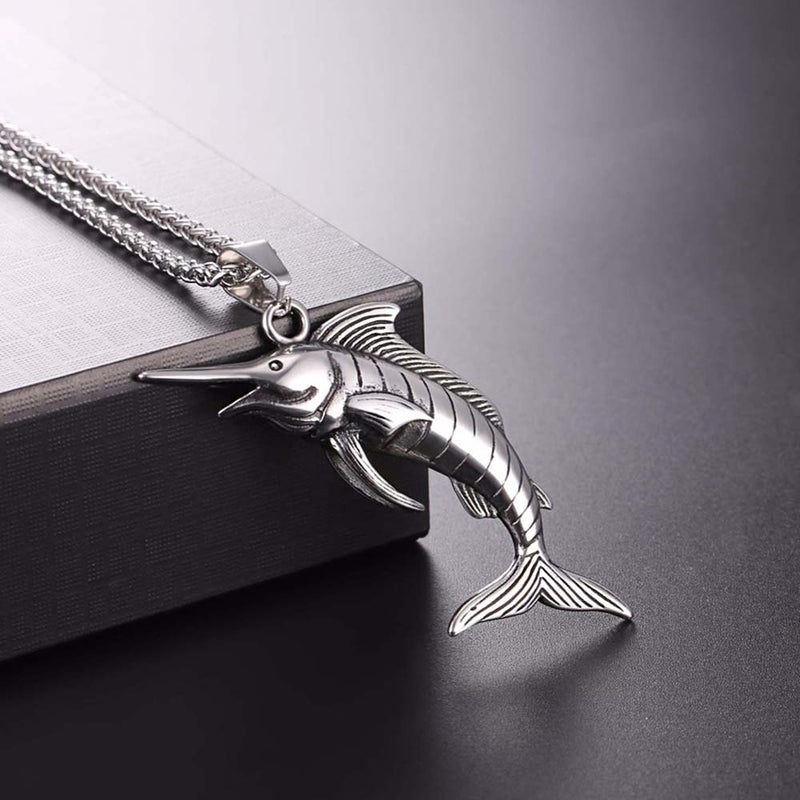 Silver Swordfish Necklace resting on table