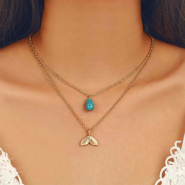 Model wearing a double chain necklace with Turquoise Charm and Mermaid tail Pendant