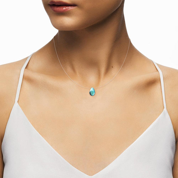 Female Model wearing a Iridescent Blue Tear shape Necklace