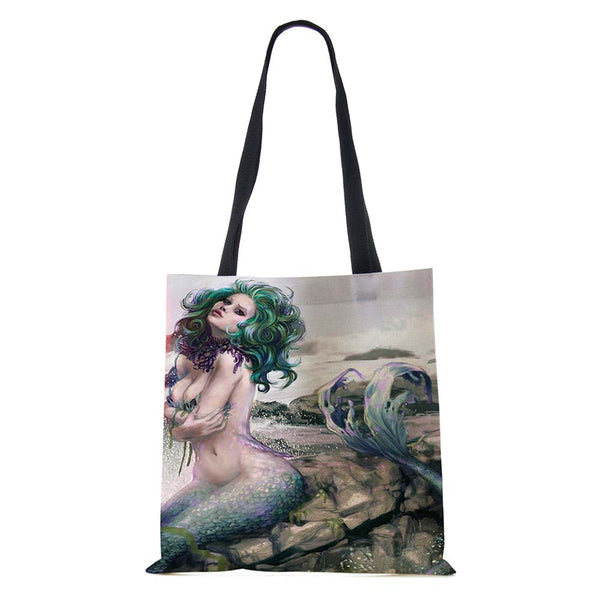 Mermaid sitting on rocks Tote Bag 