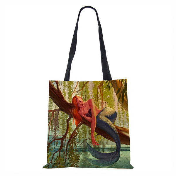 Mermaid sleeping on tree tote bag
