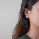 Woman model wearing a Gold Octopus Stud Earring with pearl