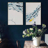 Two fish shoal canvases on a dark blue wall
