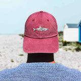 Man wearing back to front red baseball cap with shark design