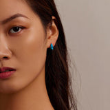 woman wearing shark stud earring front view