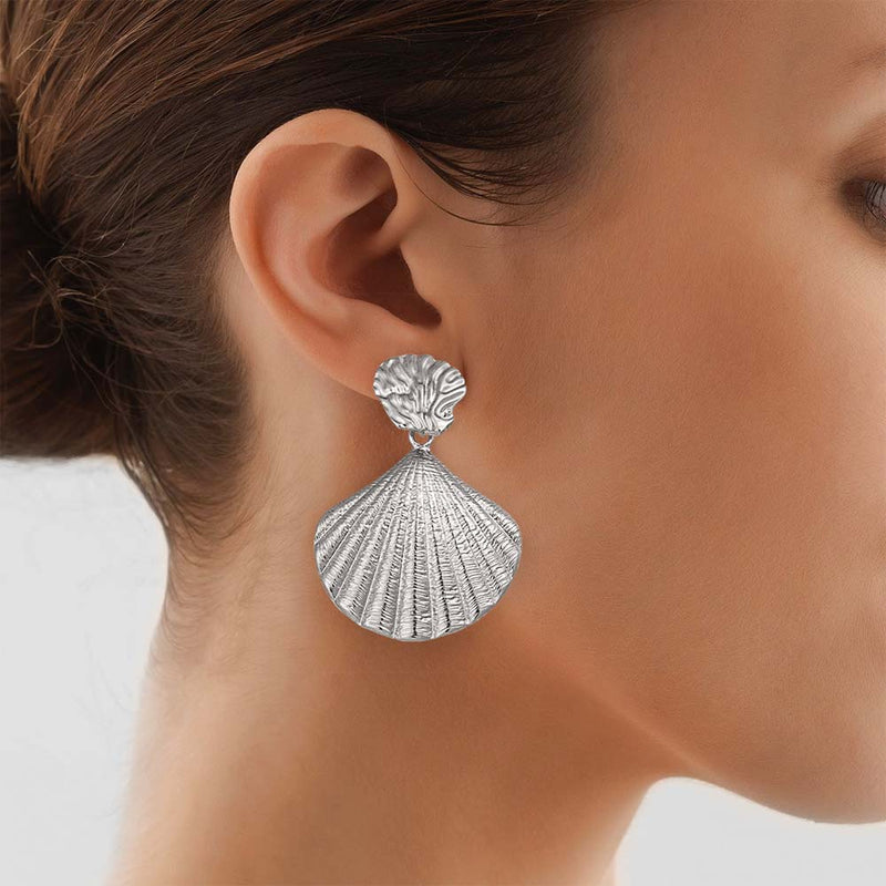 Woman wearing a large Silver Scallop Shell Earring