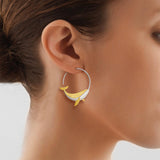 Woman wearing a silver & gold Whale Hoop Earring