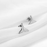 Fish tail stud earrings in Silver on white silk 